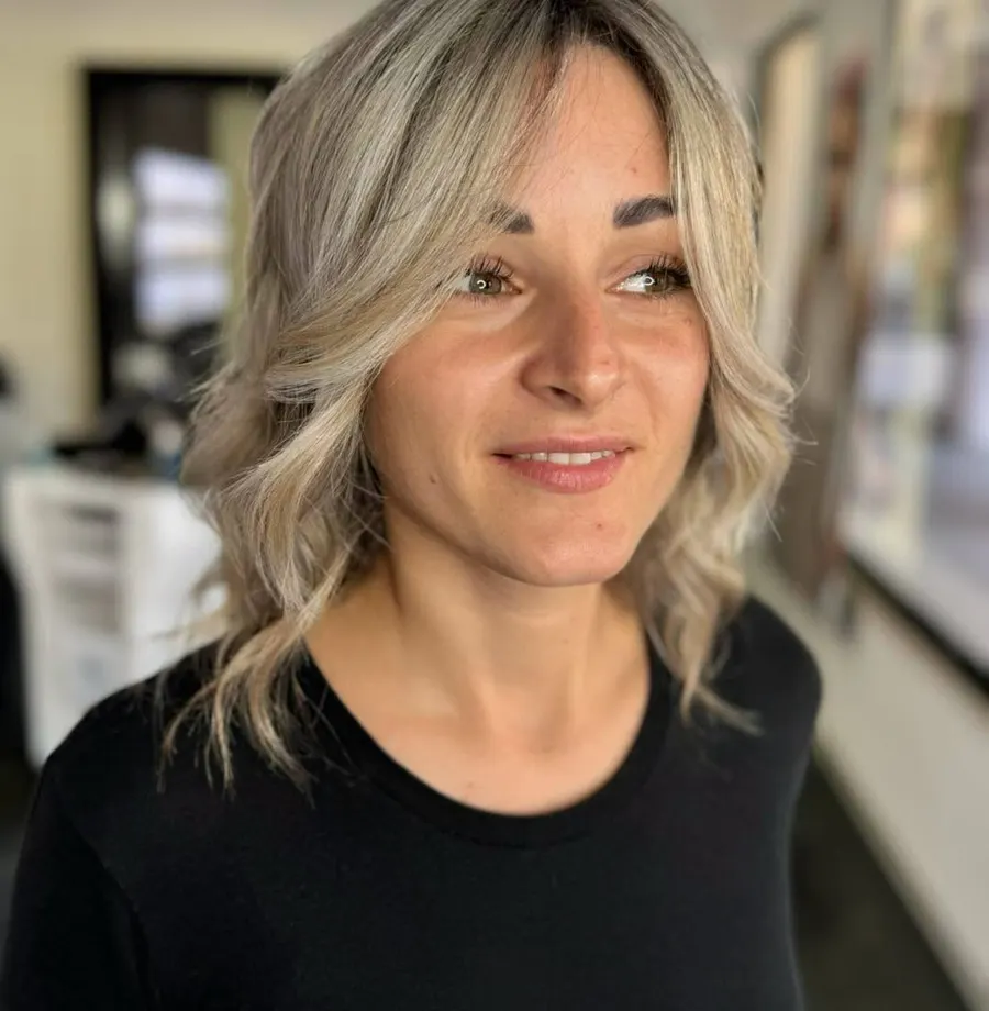Biondo scalato con onde morbide, cliente sorridente